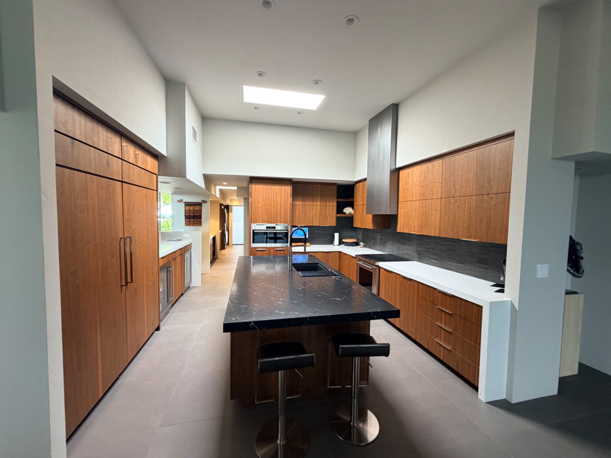 Full view of custom walnut kitchen cabinetry